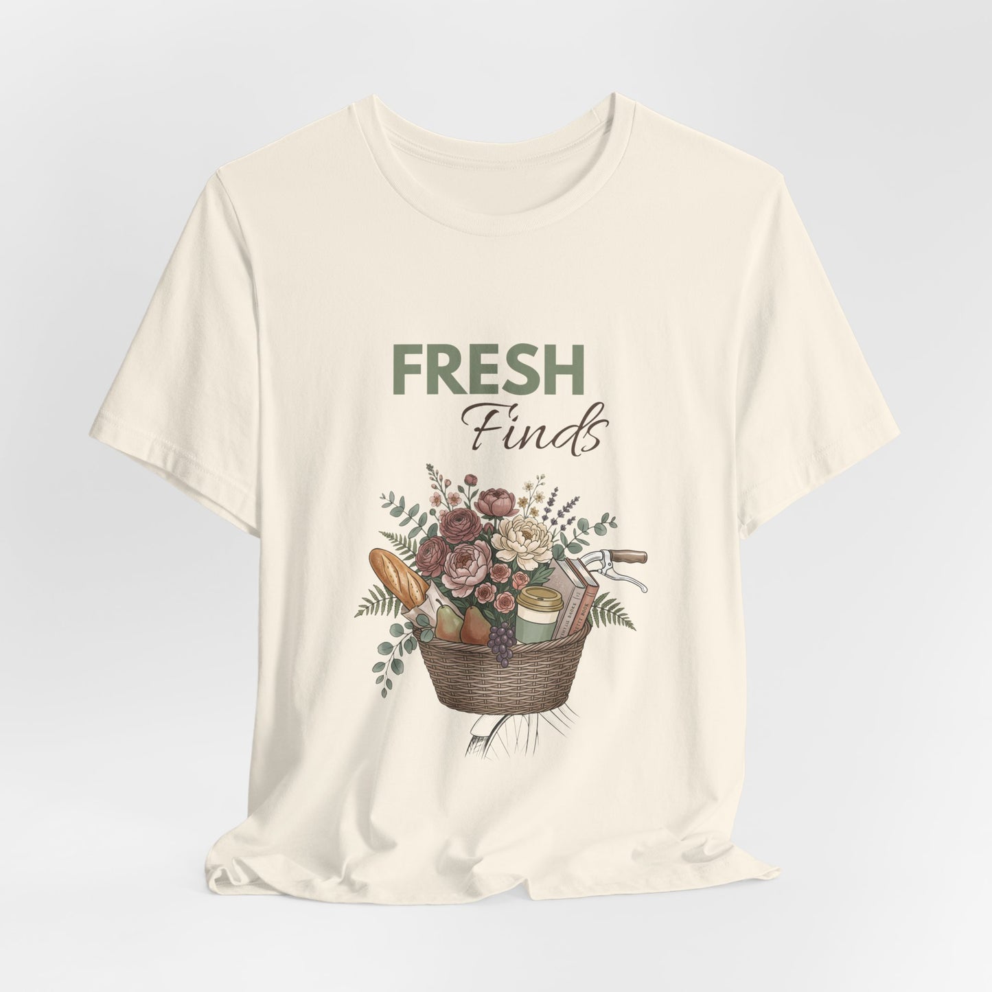 A hanging natural colored t-shirt with 'FRESH Finds' on the front.