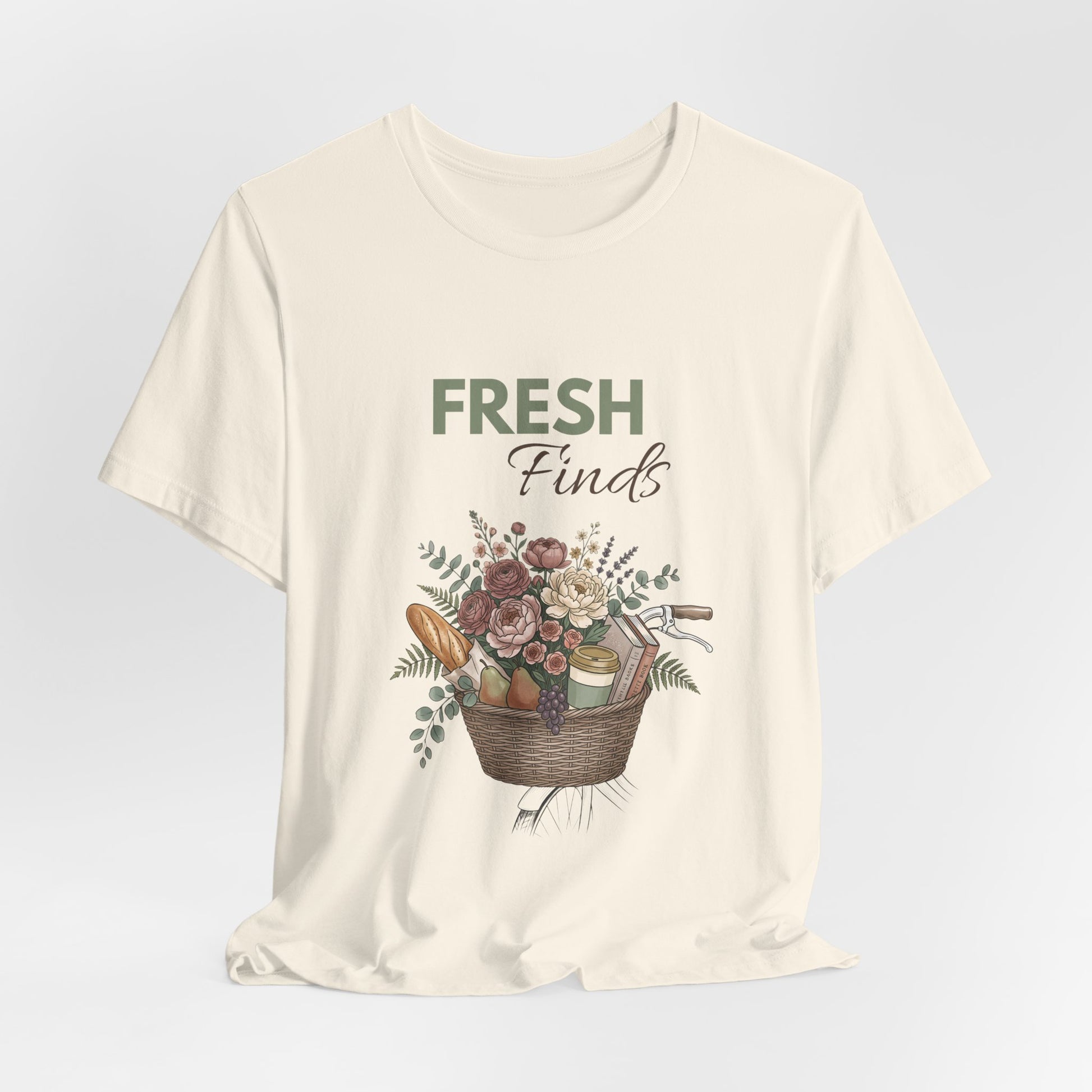 A hanging natural colored t-shirt with 'FRESH Finds' on the front.