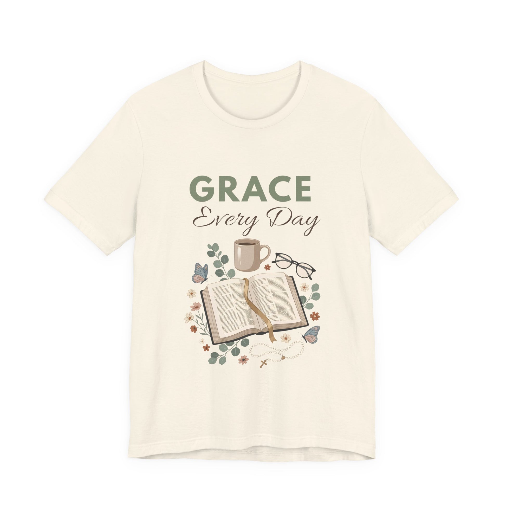 A natural colored t-shirt with 'Grace Every Day' text and book graphic on a white background