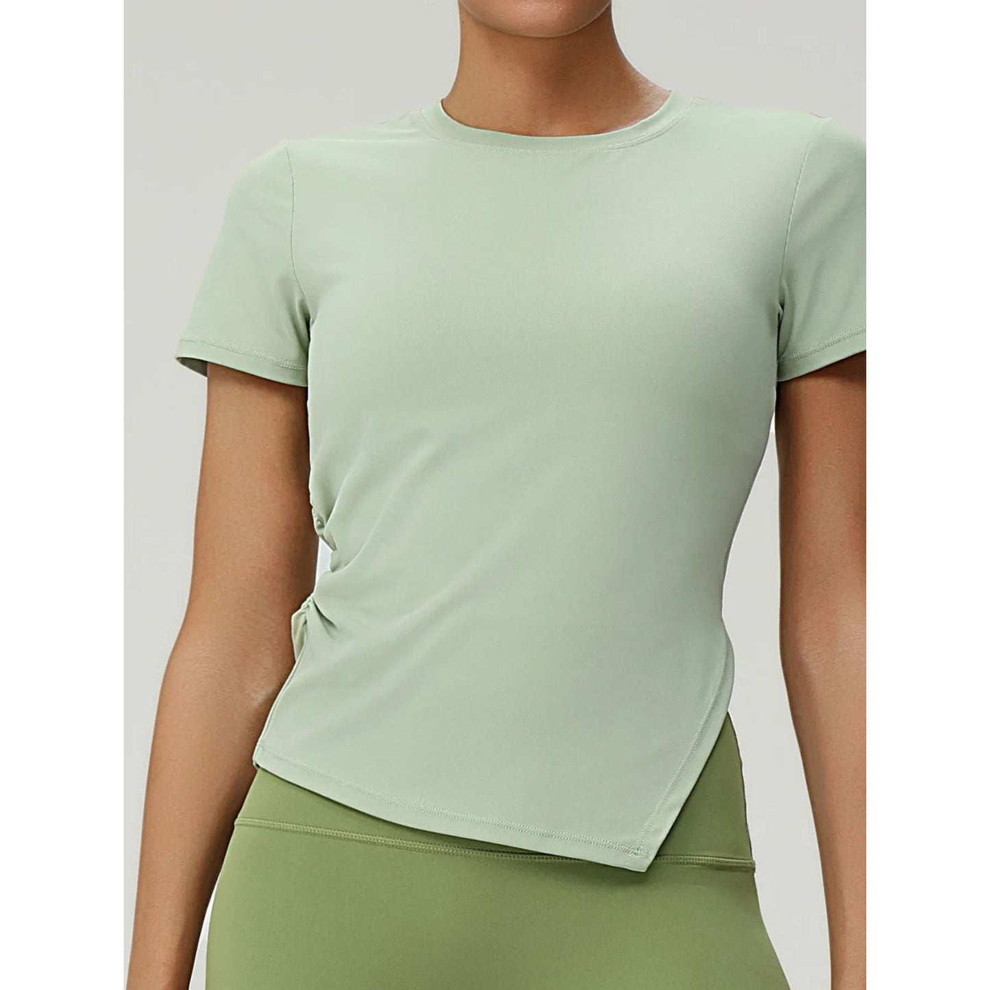Person wearing a light green athletic outfit on a plain background