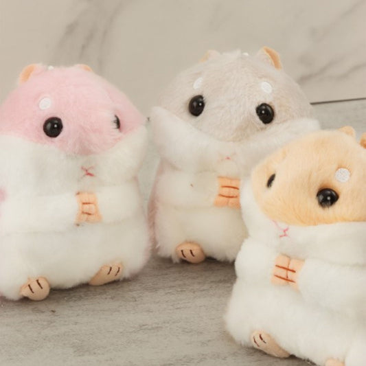 Three plush toys resembling hamsters on a neutral background