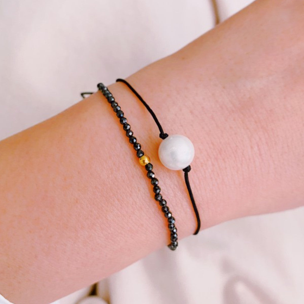 Black Genuine Pearl Dream Bracelet on wrist with white background