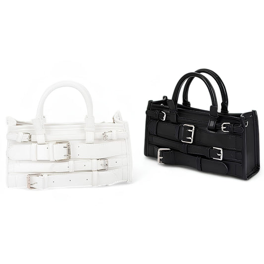 Two handbags, one transparent and one black with silver buckles, on a white background.