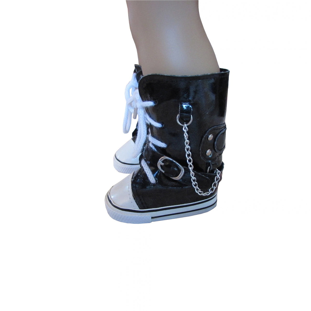 Black high-top doll boots with white laces, white rubber toe caps and soles, and silver chain and buckle details, shown on a mannequin leg against a white background.