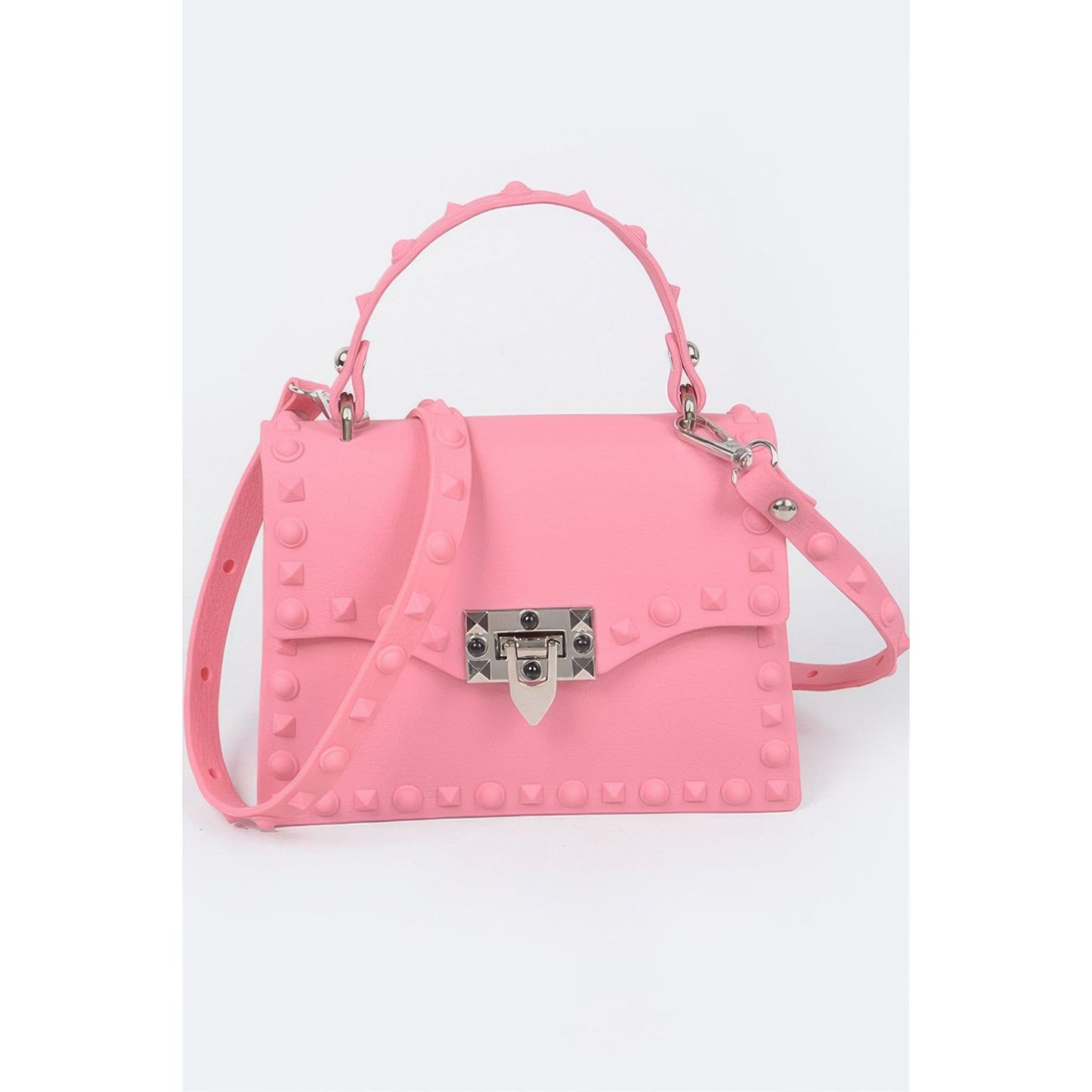 A pink faux-leather handbag with a top handle and shoulder strap, decorated with silver studs and featuring a silver metal clasp on the front flap.
