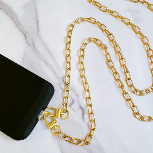 Gold chain with a black pouch on a white background