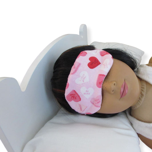 18 inch doll with a pink heart-patterned sleep mask on a white background