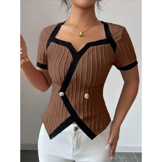 Brown ribbed sweater with black accents worn by a person, against a neutral background