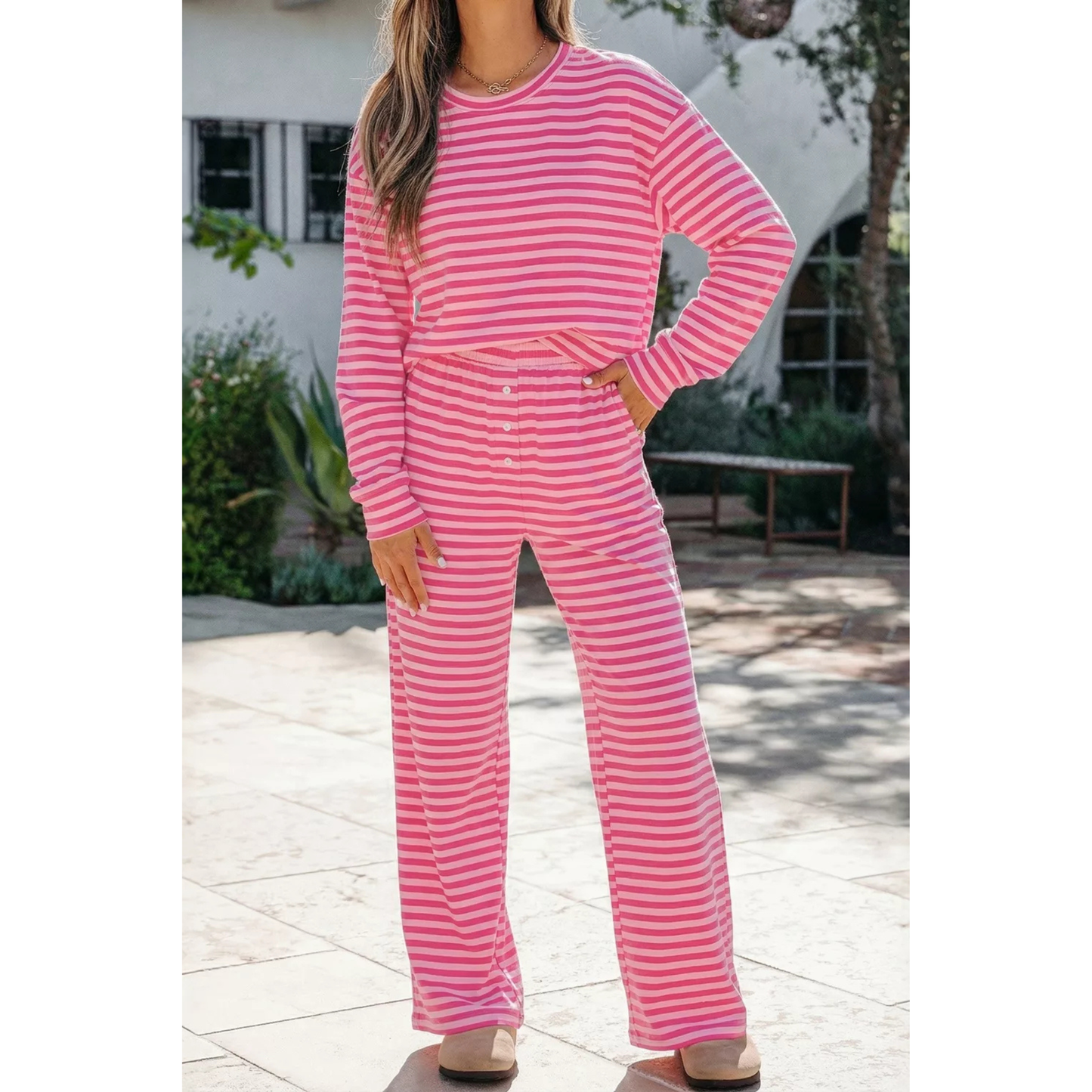 Woman wearing a dusty pink striped long sleeve top and pants.