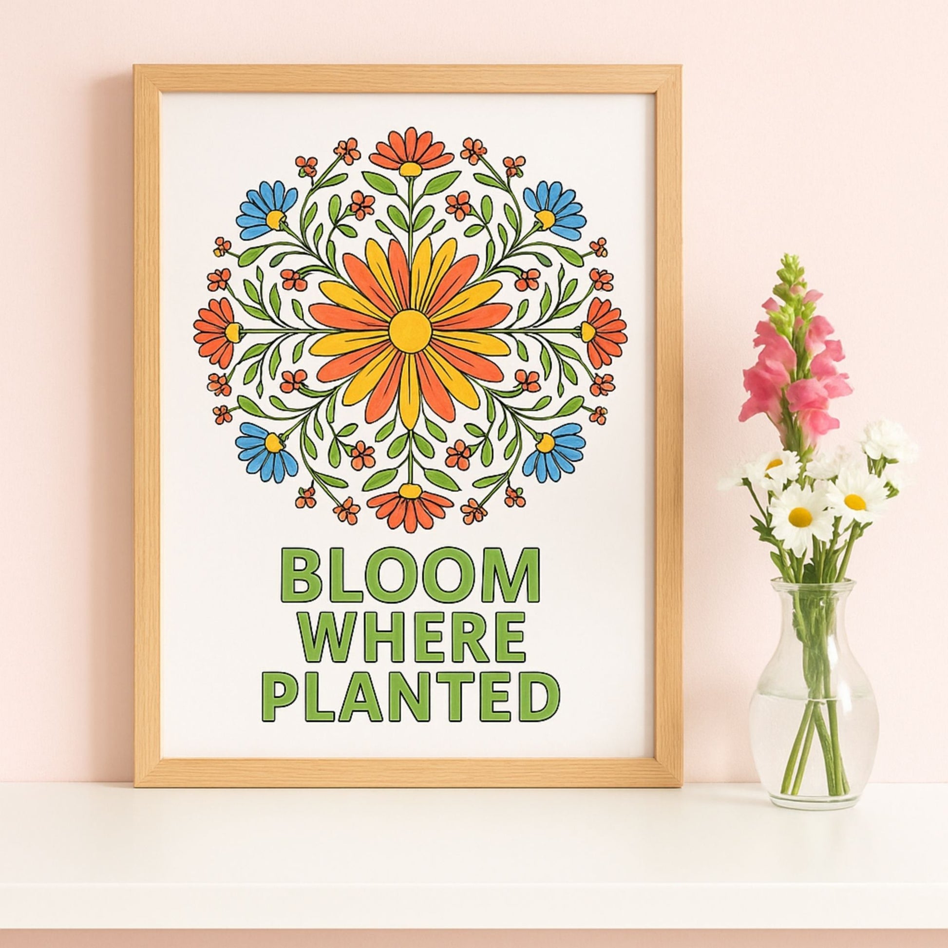 Framed floral artwork with 'Bloom Where Planted' text on a wall.