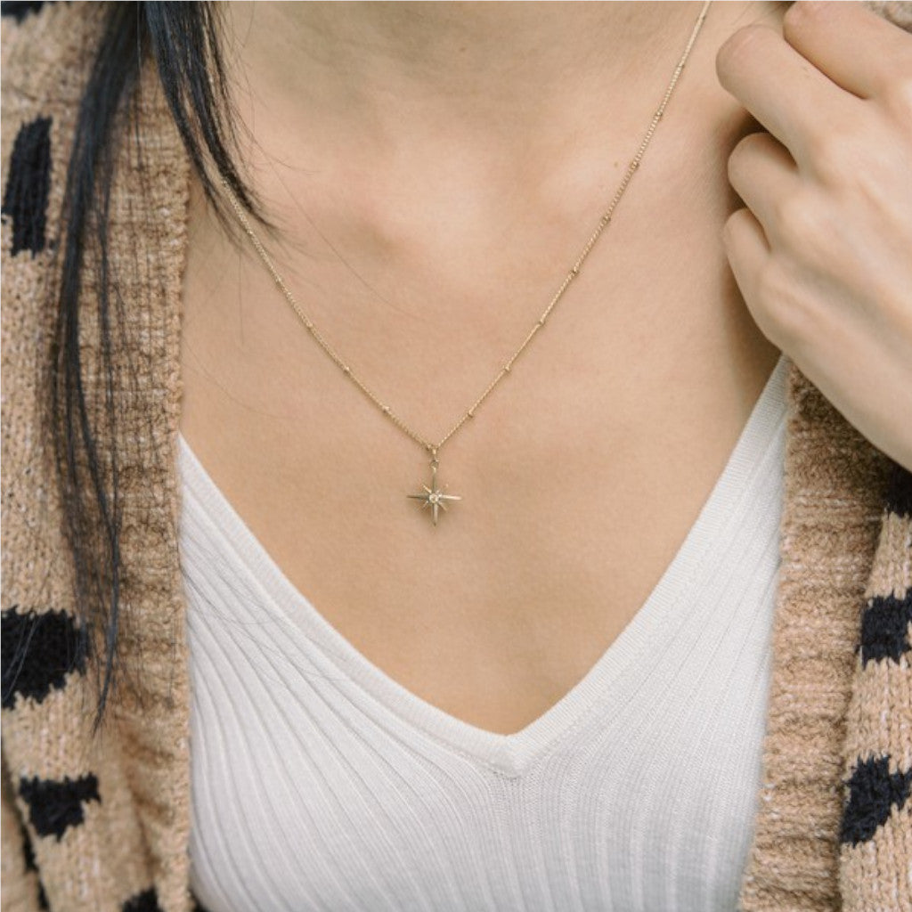 Gold North Star Necklace on neck