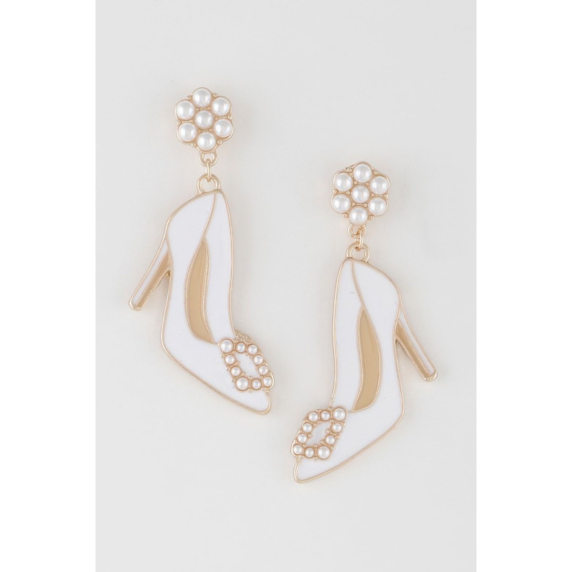 Pair of high-heeled shoe earrings with pearl embellishments on a light gray background