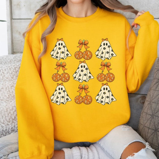 Person wearing a yellow sweatshirt with Halloween-themed graphics