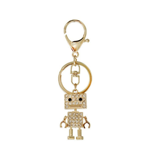 Gold robot keychain with clear gemstones on a white background