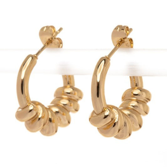 Gold hoop earrings with a textured design on a white background