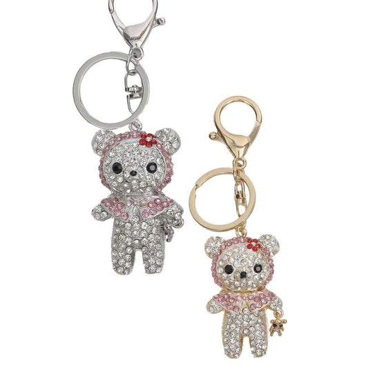 Two teddy bear keychains, one silver and one gold, on a white background.