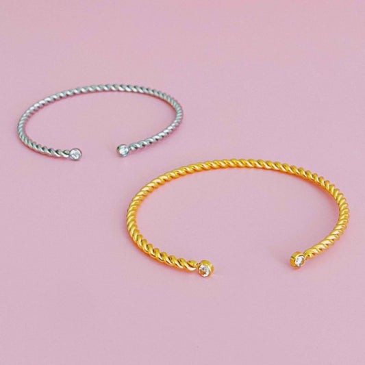Gold and Silver Cabled Open Bangle Bracelet on pink background