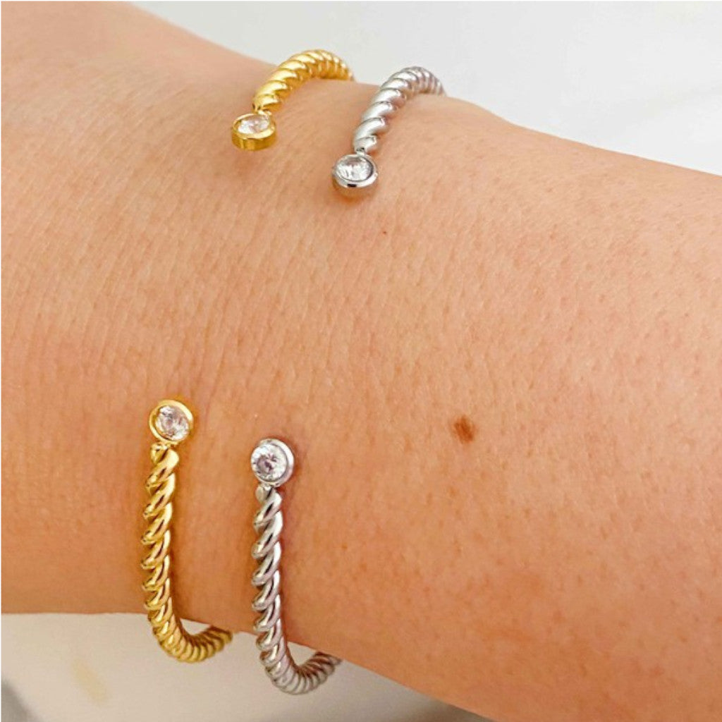 Gold and Silver Cabled Open Bangle Bracelets on wrist with white background