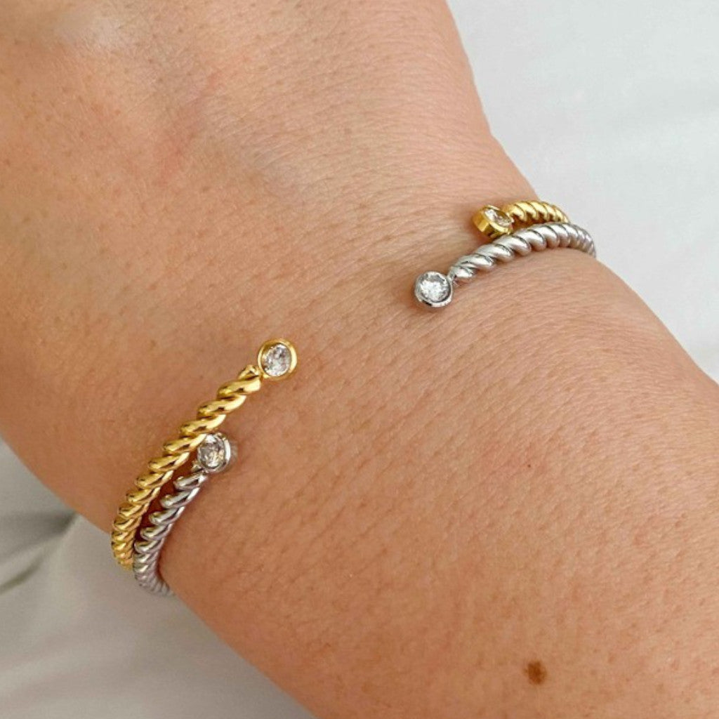 Gold and Silver Cabled Open Bangle Bracelets on wrist with white background