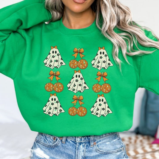 Person wearing a green sweatshirt with Halloween-themed graphics