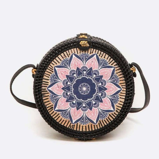 Round woven bag with a mandala design on a white background