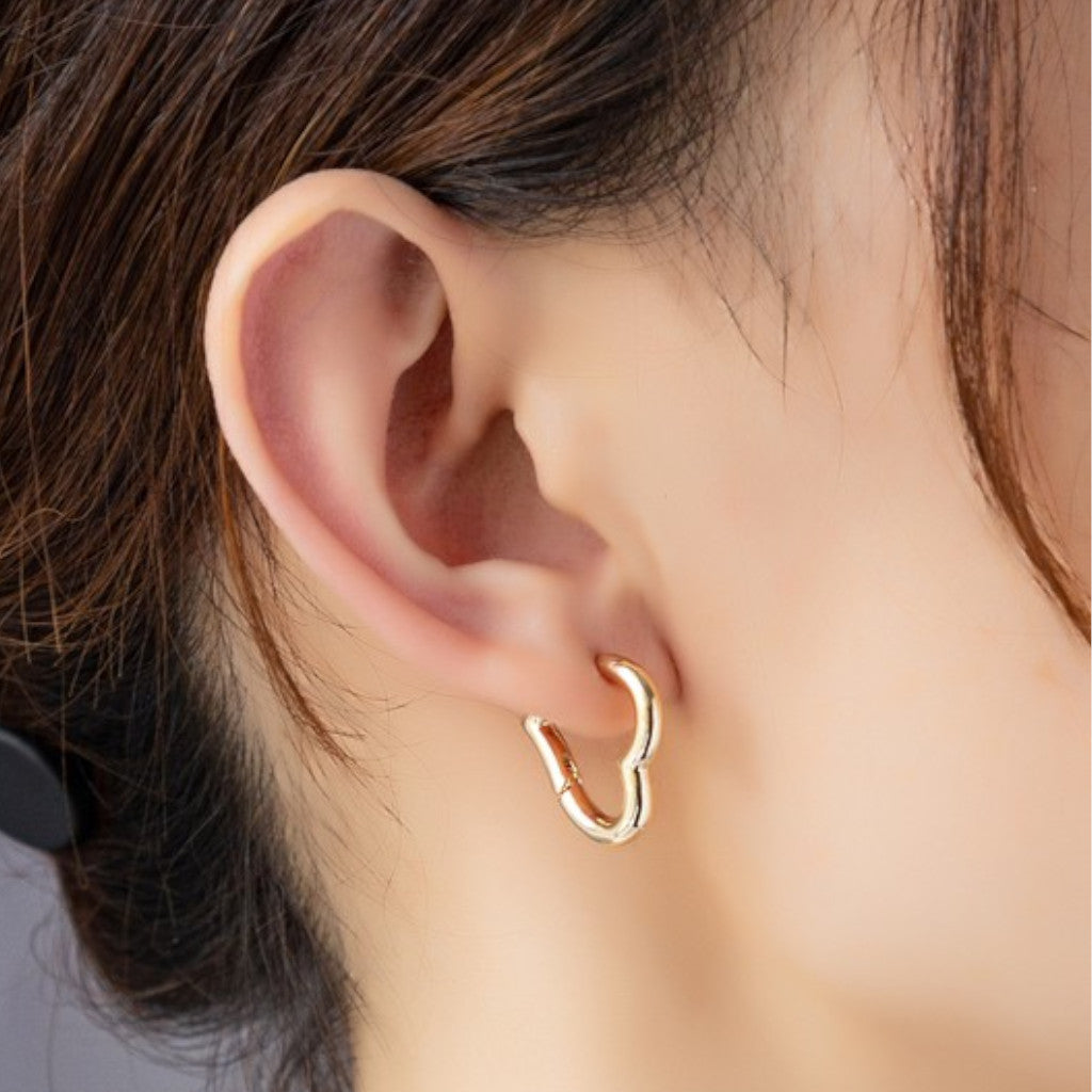 Hearr Shaped Hinged Hoop Earrings on Woman's Ear