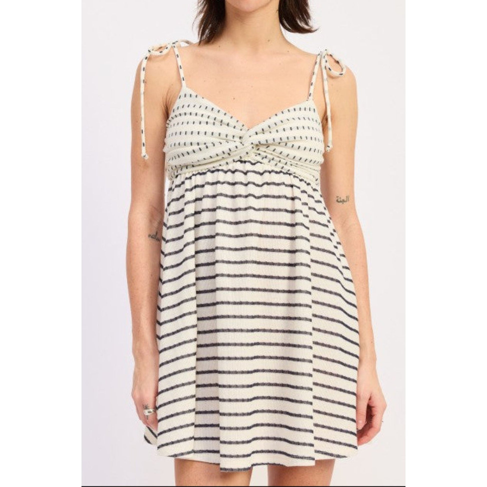 Woman wearing a black and white striped dress on a white background