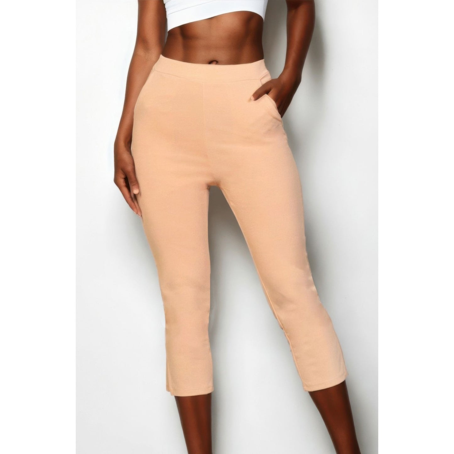 Beige pants worn by a person on a white background