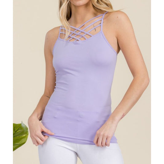Woman wearing a light purple tank top with criss-cross straps on a beige background