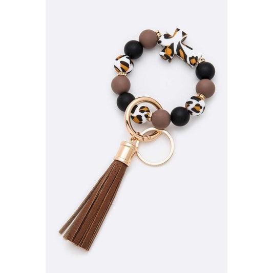 Bracelet with leopard print beads and a tassel on a white background