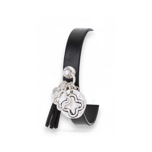 Black leather bracelet with silver charms on a white background