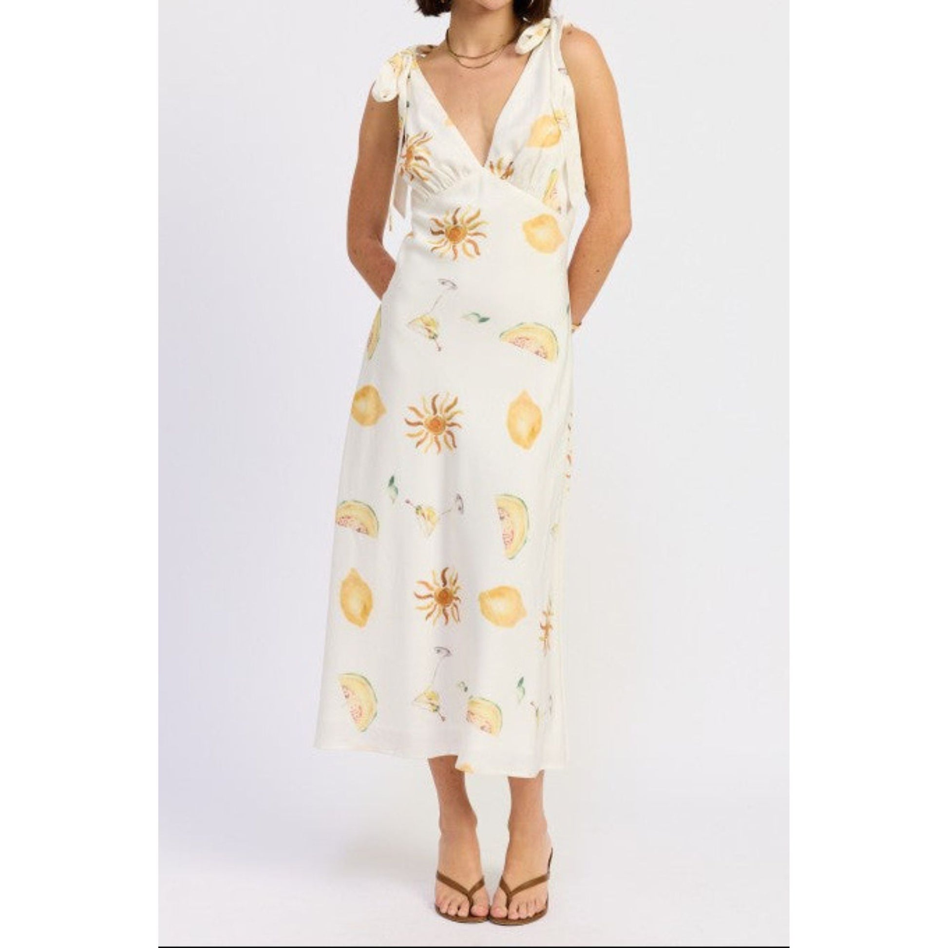 White dress with yellow floral patterns on a white background