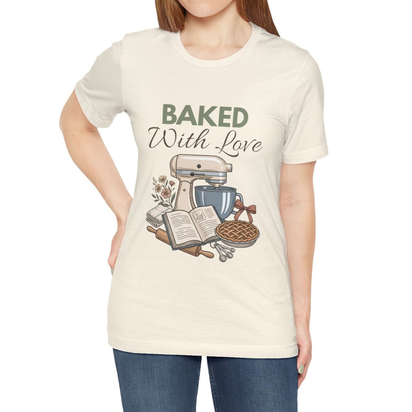 A woman wearing a natural t-shirt with 'BAKED With Love' on the front.
