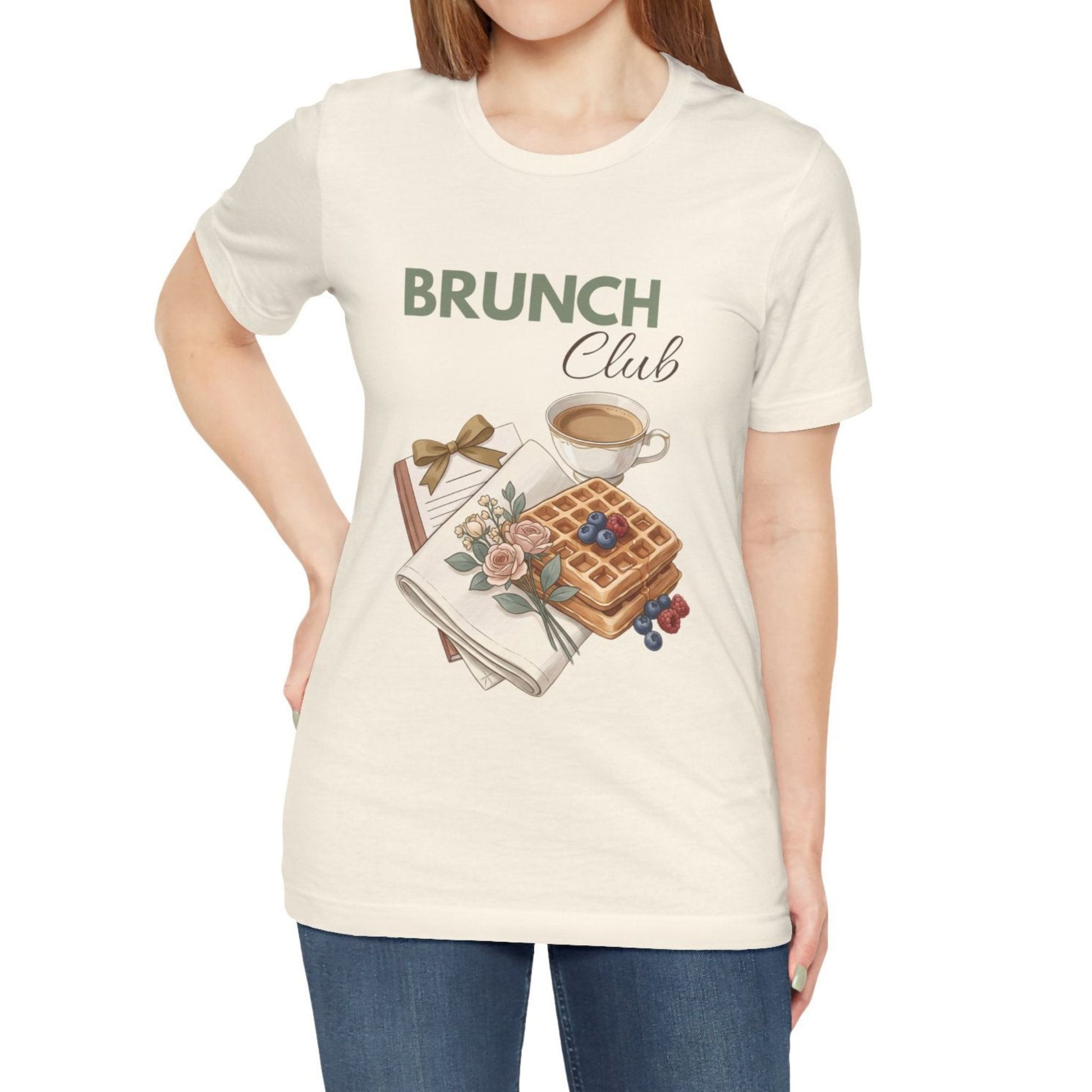 A woman is wearing a natural colored t-shirt with 'BRUNCH Club' on the front.