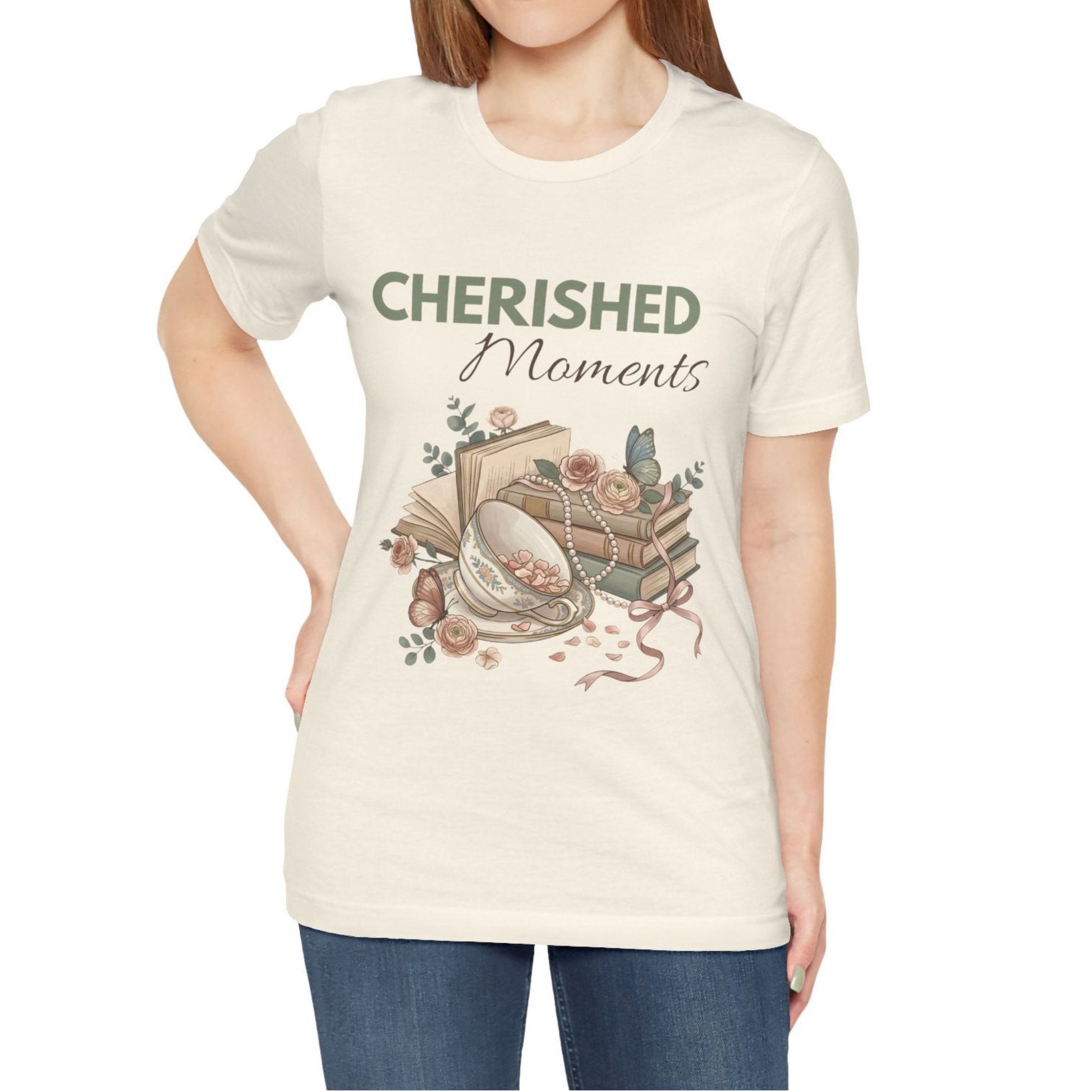 A woman is wearing a natural colored t-shirt with 'CHERISHED Moments' on the front.