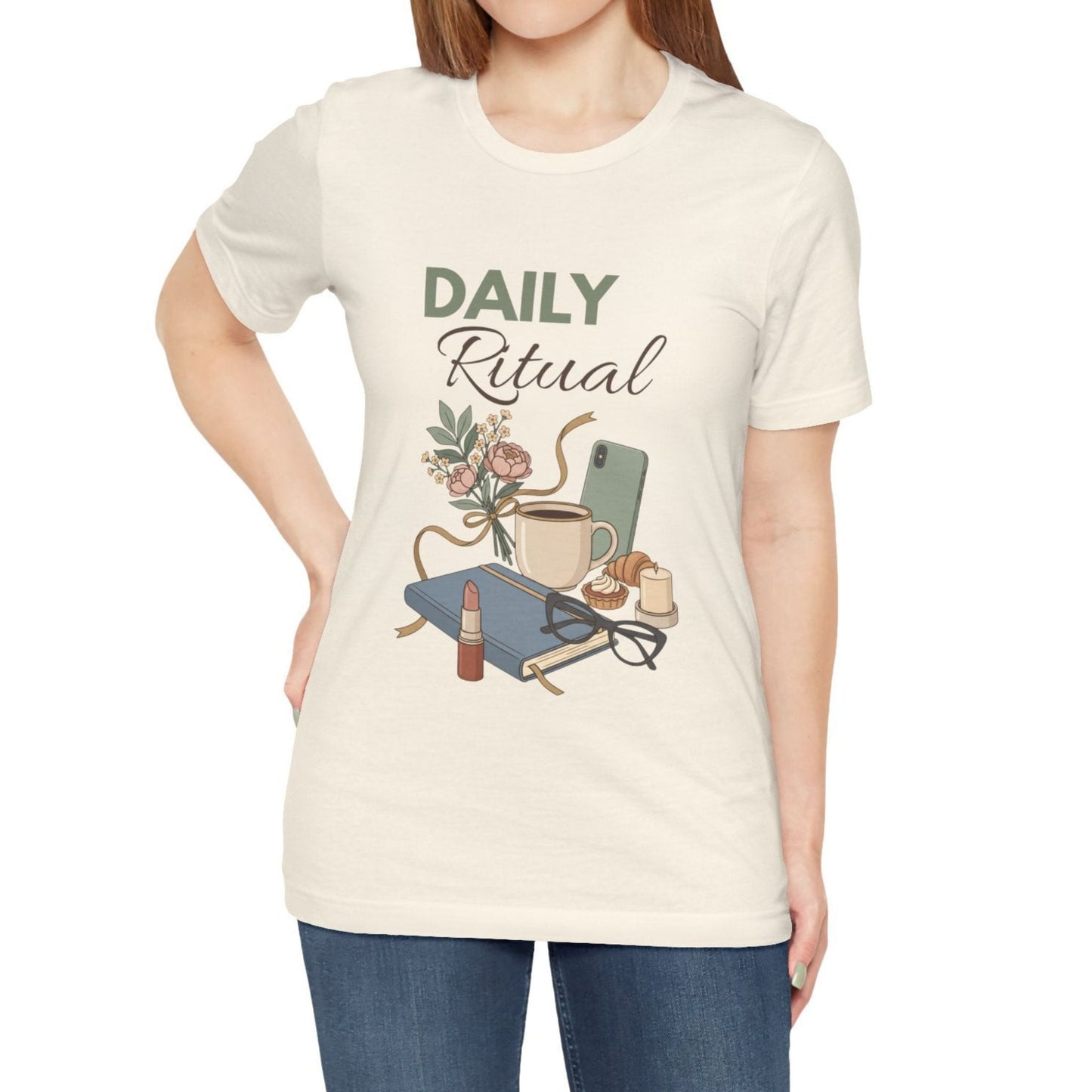 Person wearing a natural colored t-shirt with 'Daily Ritual' design on a plain background