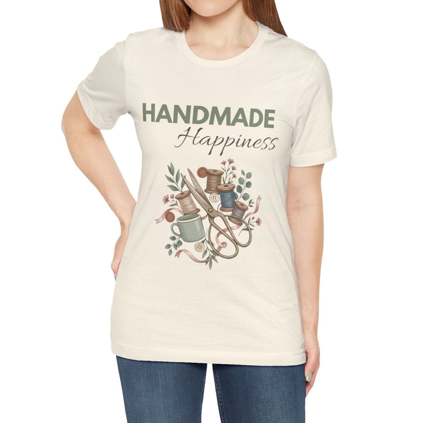 A woman wearing a natural colored t-shirt with 'HANDMADE Happiness' on the front.