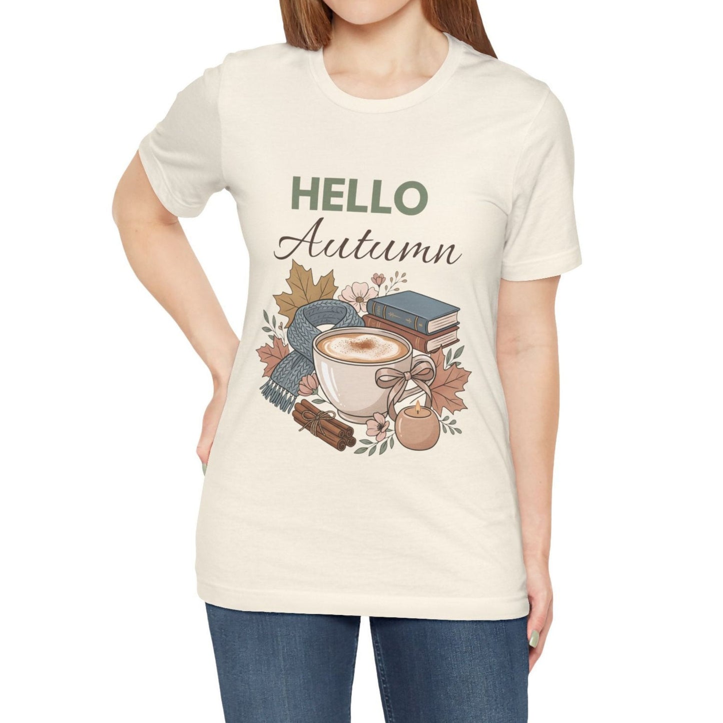 Person wearing a natural colored t-shirt with 'Hello Autumn' graphic design.
