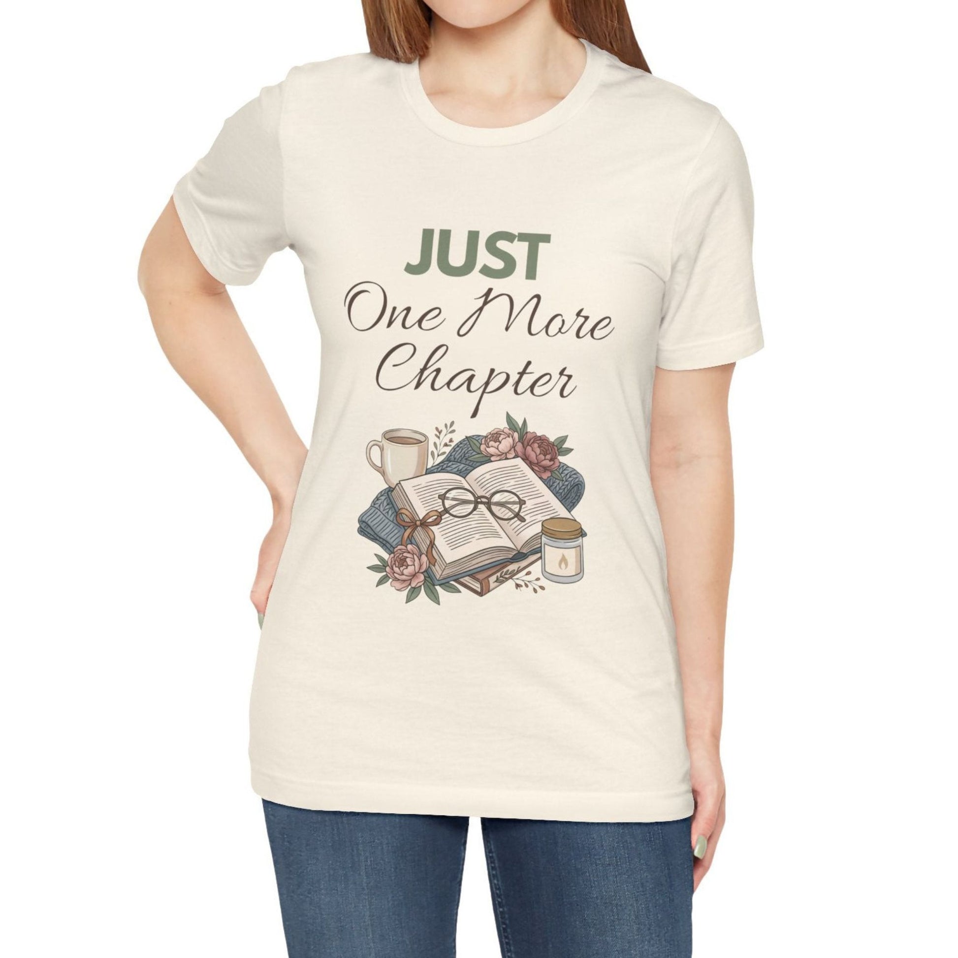 Person wearing a natural colored t-shirt with 'Just One More Chapter' design on a white background