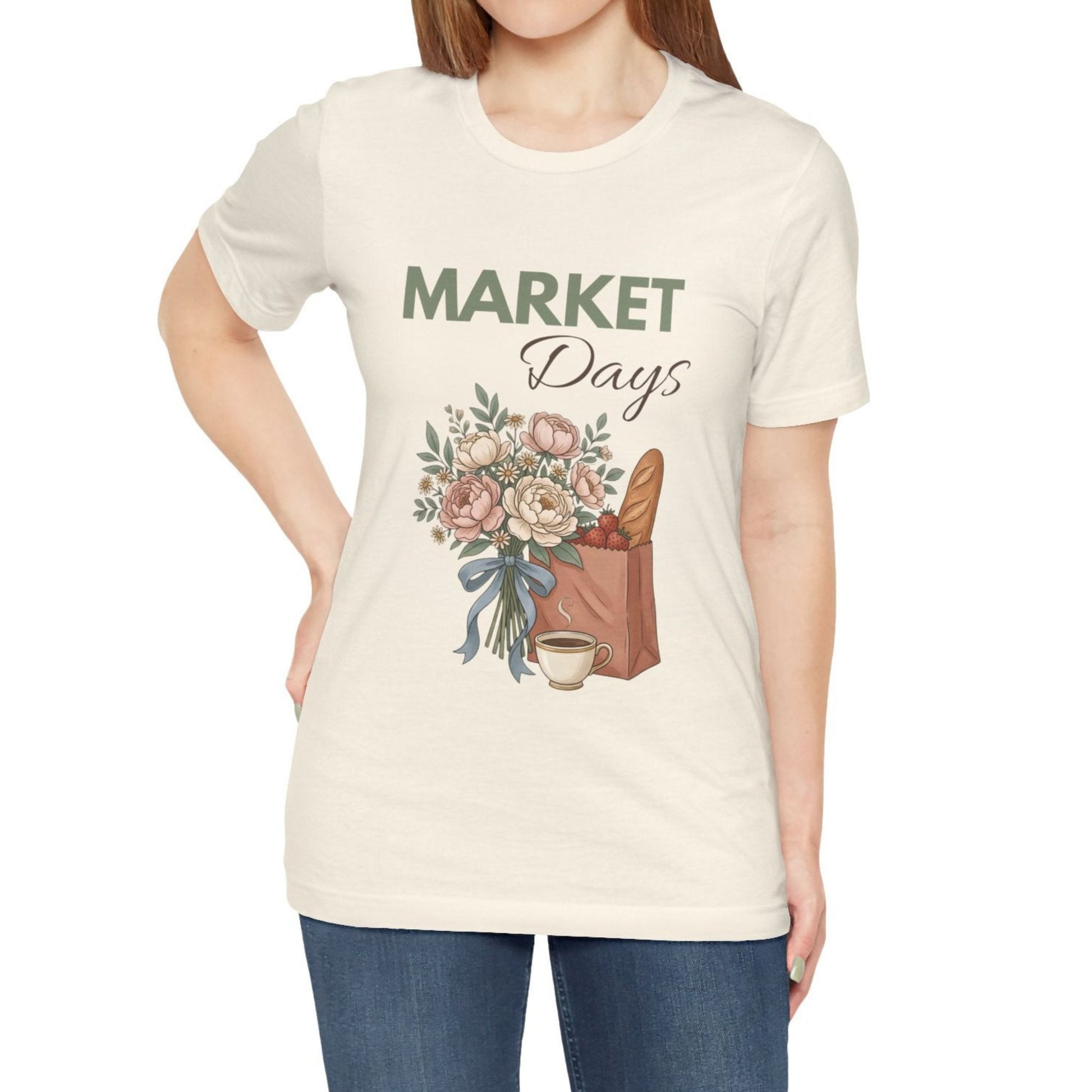 A woman wearing a natural colored t-shirt with 'Market Days' on the front.