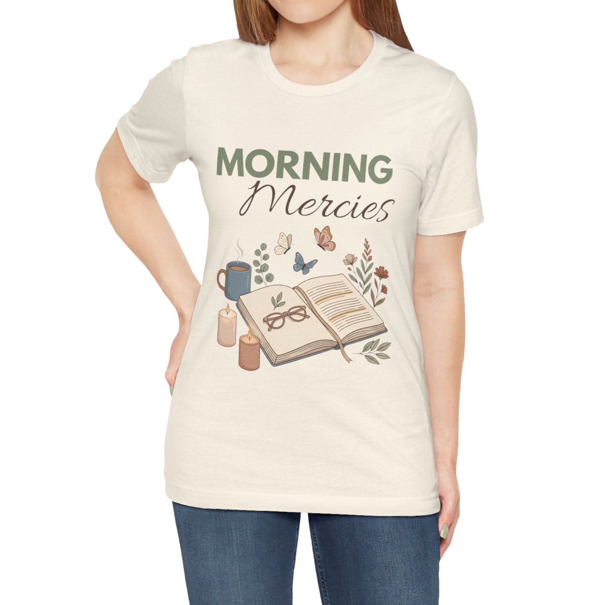Person wearing a natural colored t-shirt with 'Morning Mercies' design on a white background
