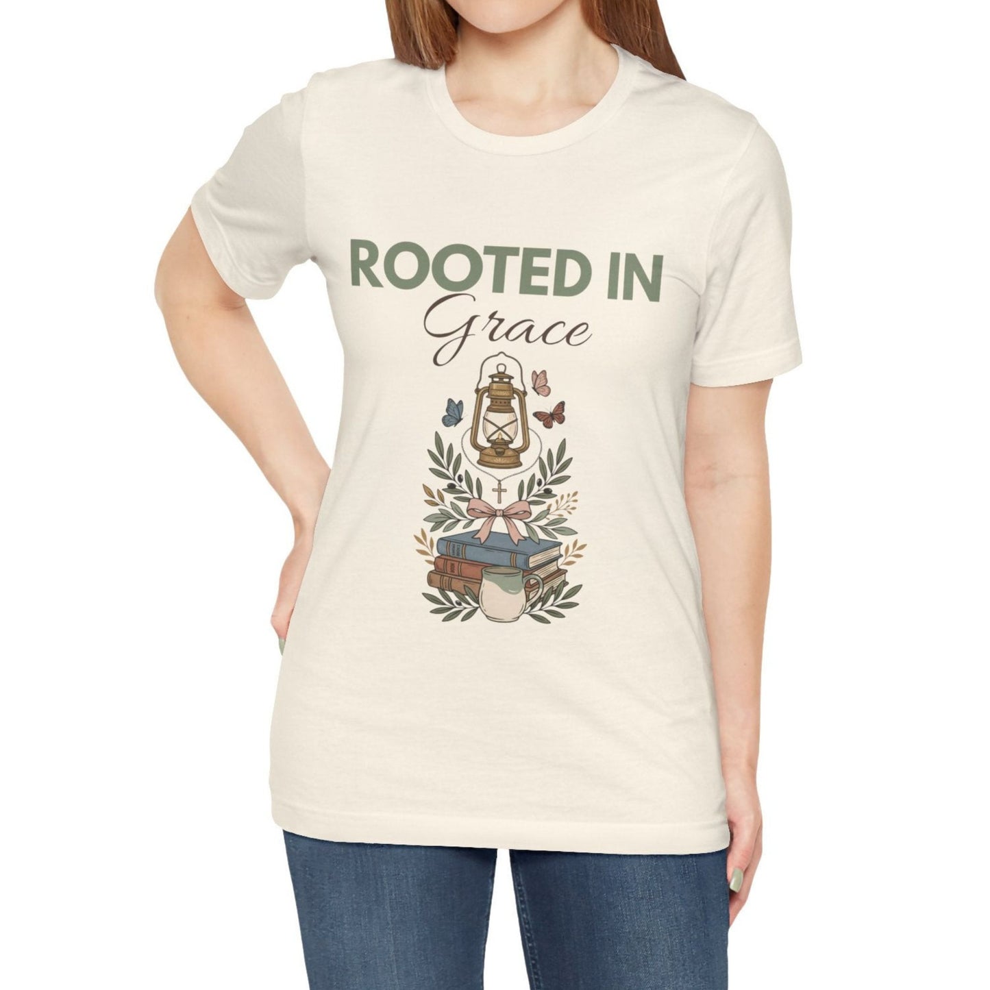 Person wearing a natural colored t-shirt with 'Rooted in Grace' design on a white background