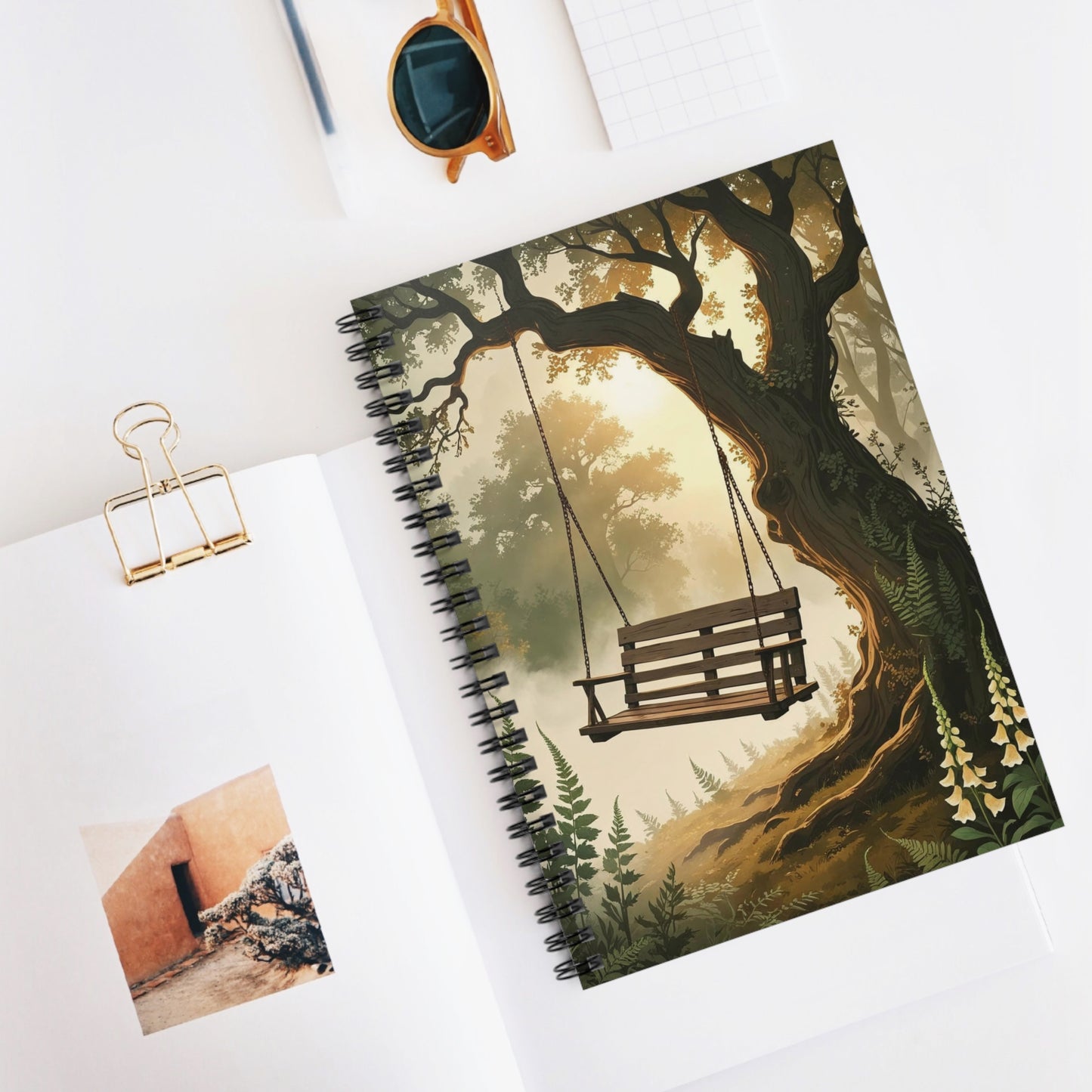 Notebook with a tree and swing design on a white surface