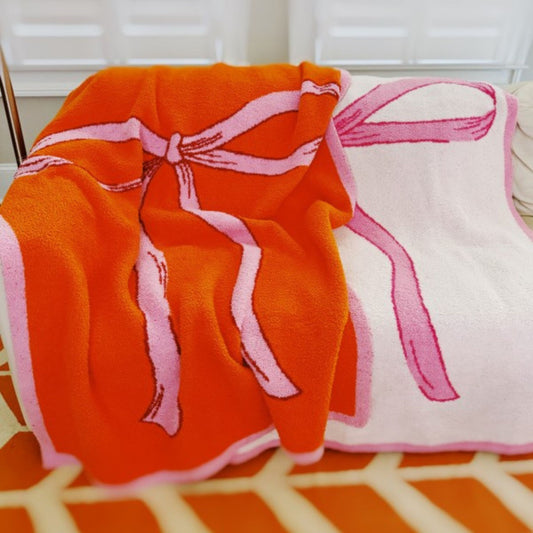 Orange and pink patterned blanket draped over a chair