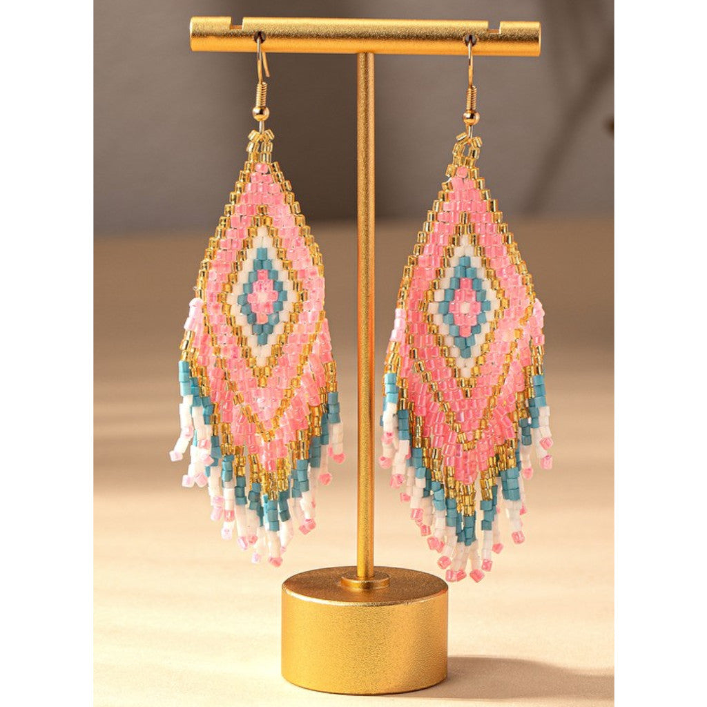 Pink Boho Seed Bead Drop Earrings on stand