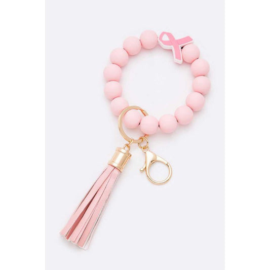 Pink beaded keychain with a tassel on a white background