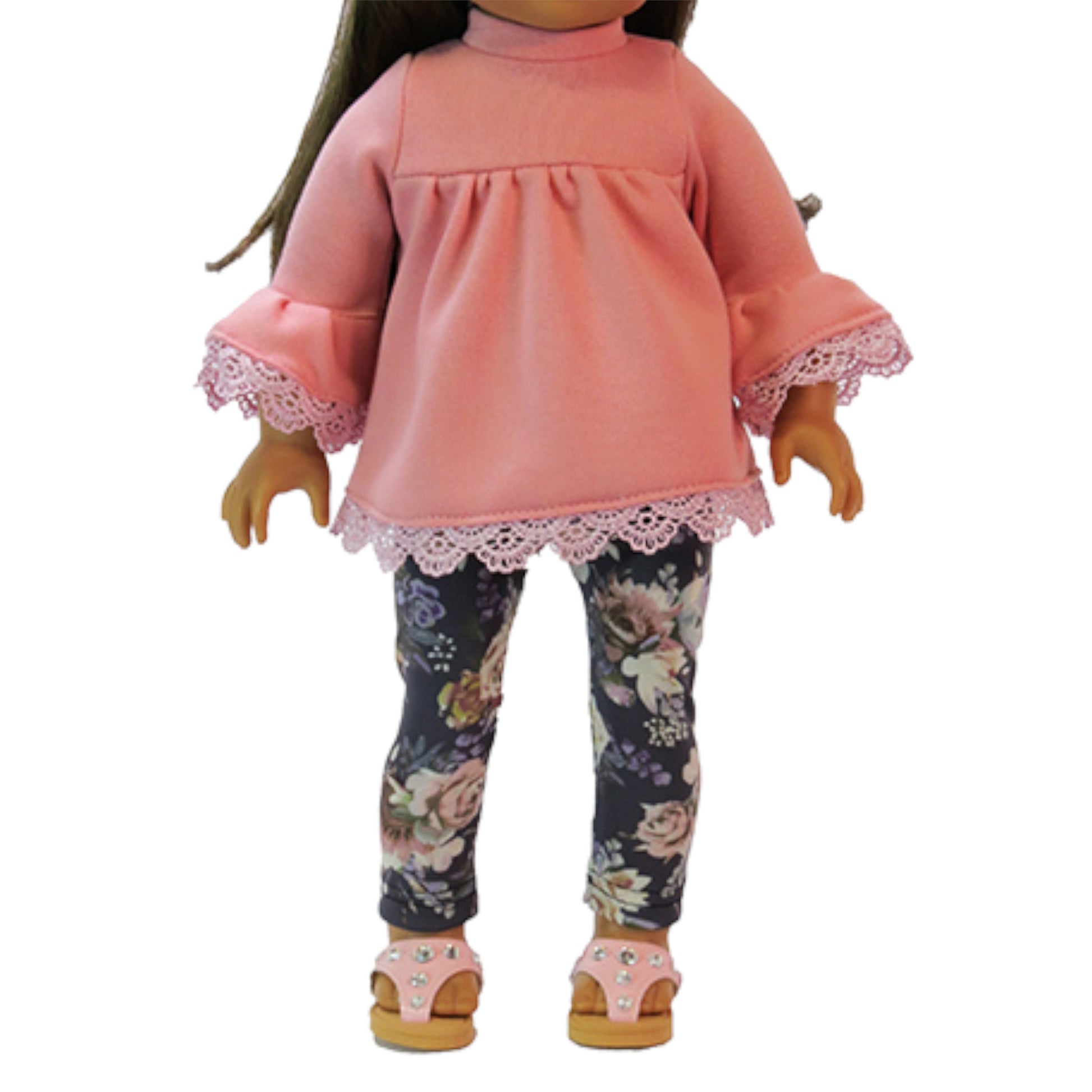 Doll wearing a pink top and floral leggings on a white background