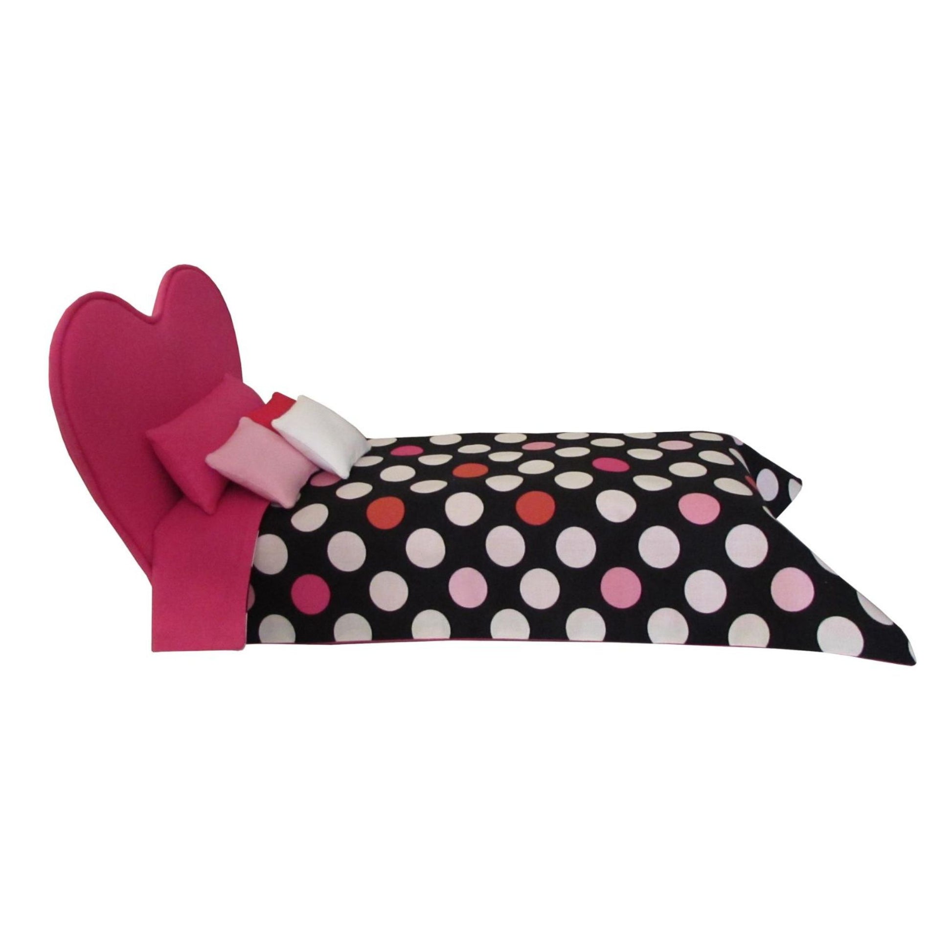 Polka dot pillow with pink heart and bow on a white background