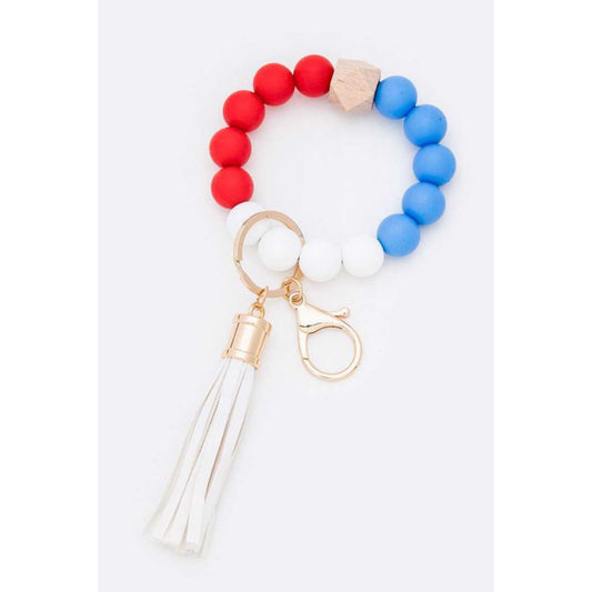 Colorful beaded keychain with a tassel on a white background