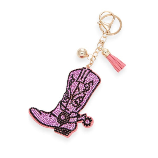 Pink cowboy boot keychain with a tassel on a white background